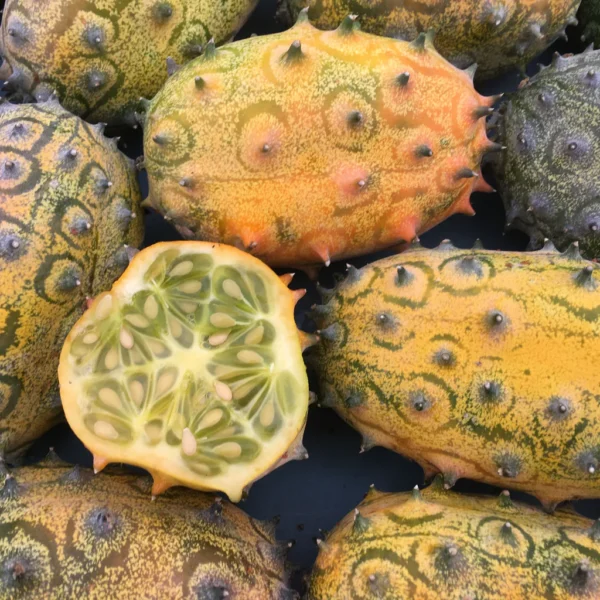 Close up on several melons with one cut in half.